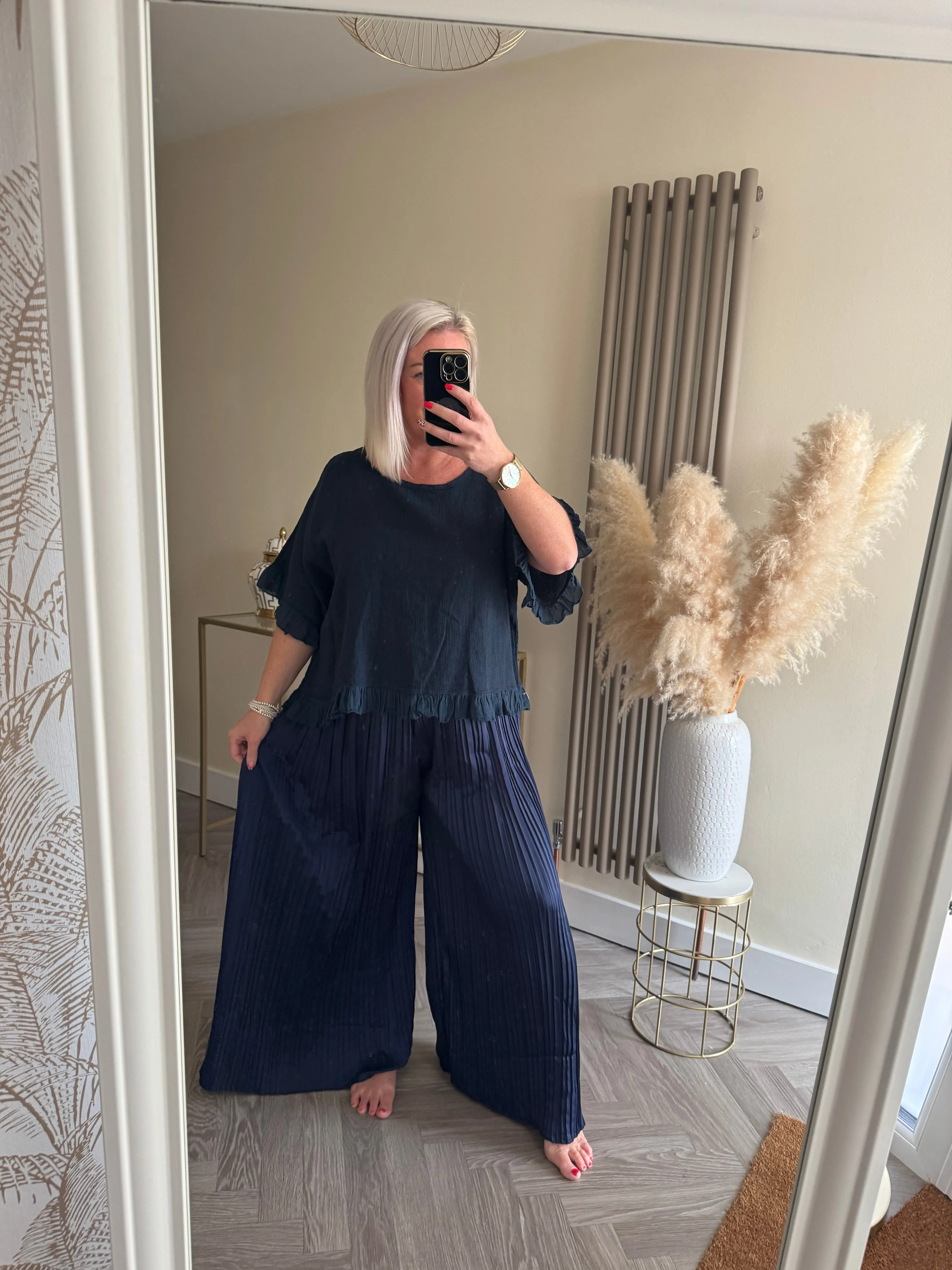 The satin pleated trousers